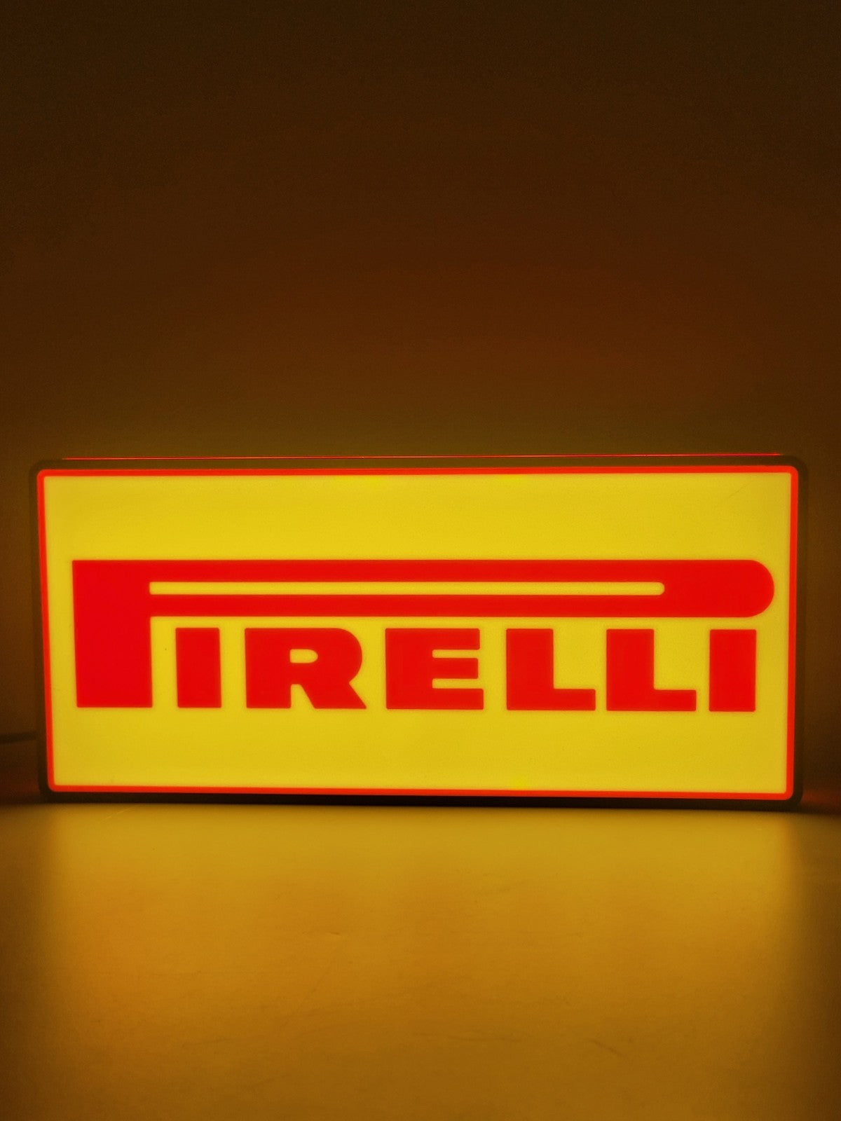 Pirelli LED light sign with illuminated logo viewed from straight on