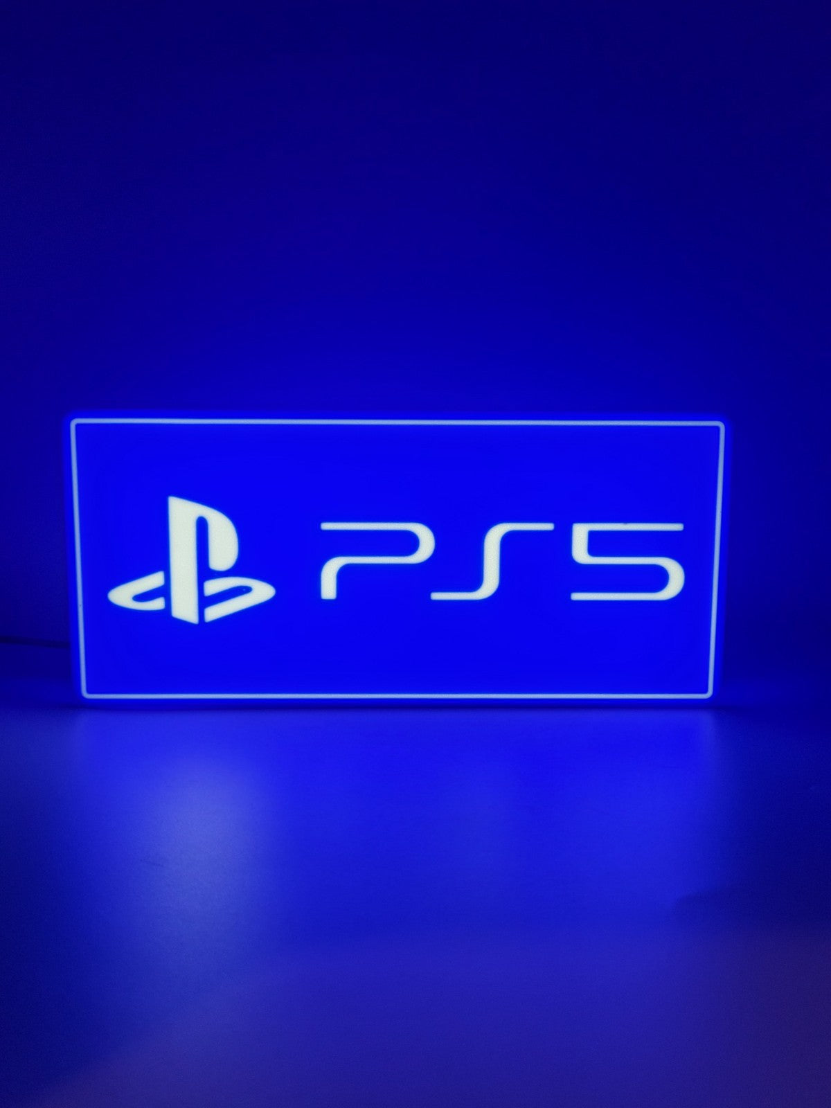 Playstation 5 LED light sign with illuminated logo viewed from straight on