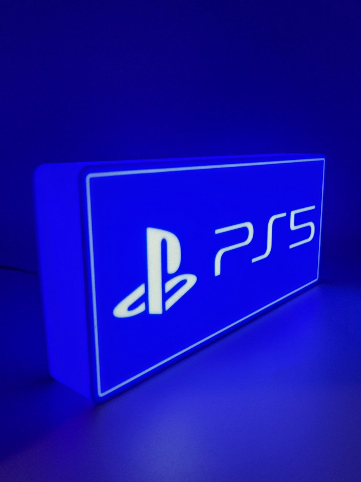 Play Station LED light sign with illuminated logo viewed from side view