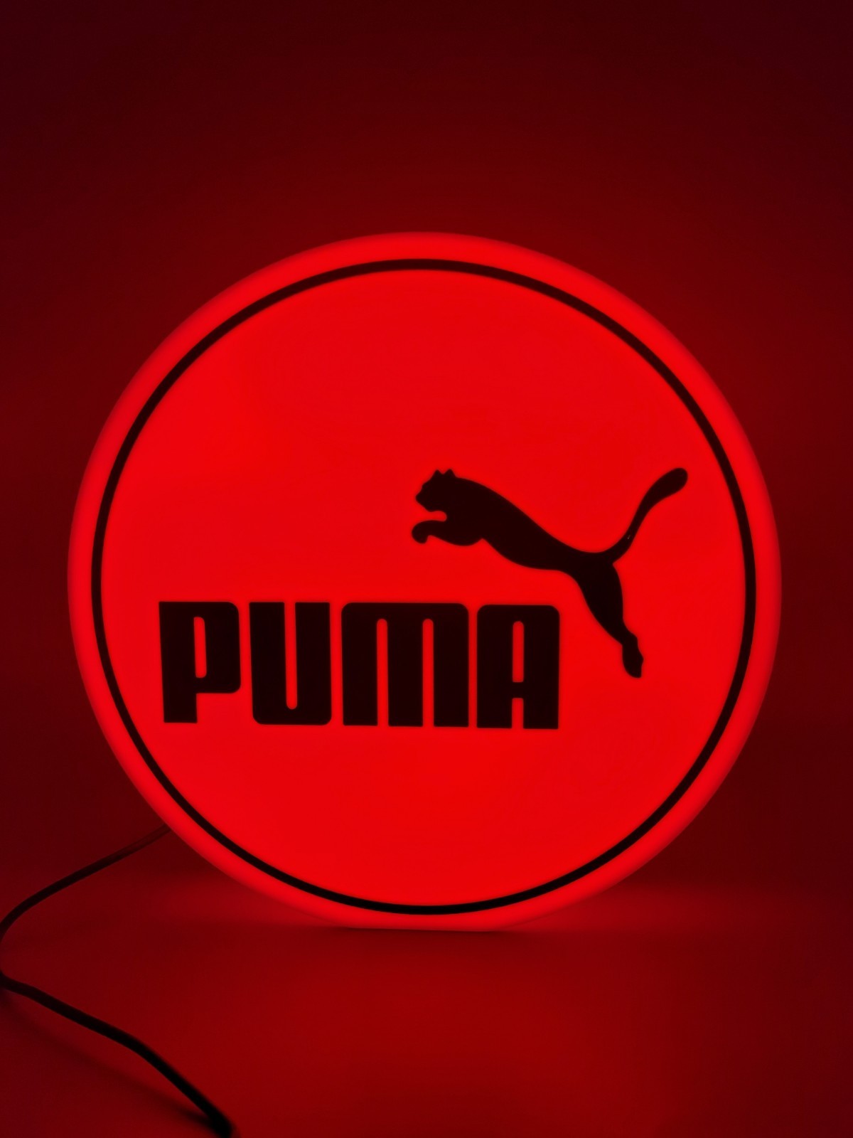 PUMA LED light sign with illuminated logo viewed from straight on