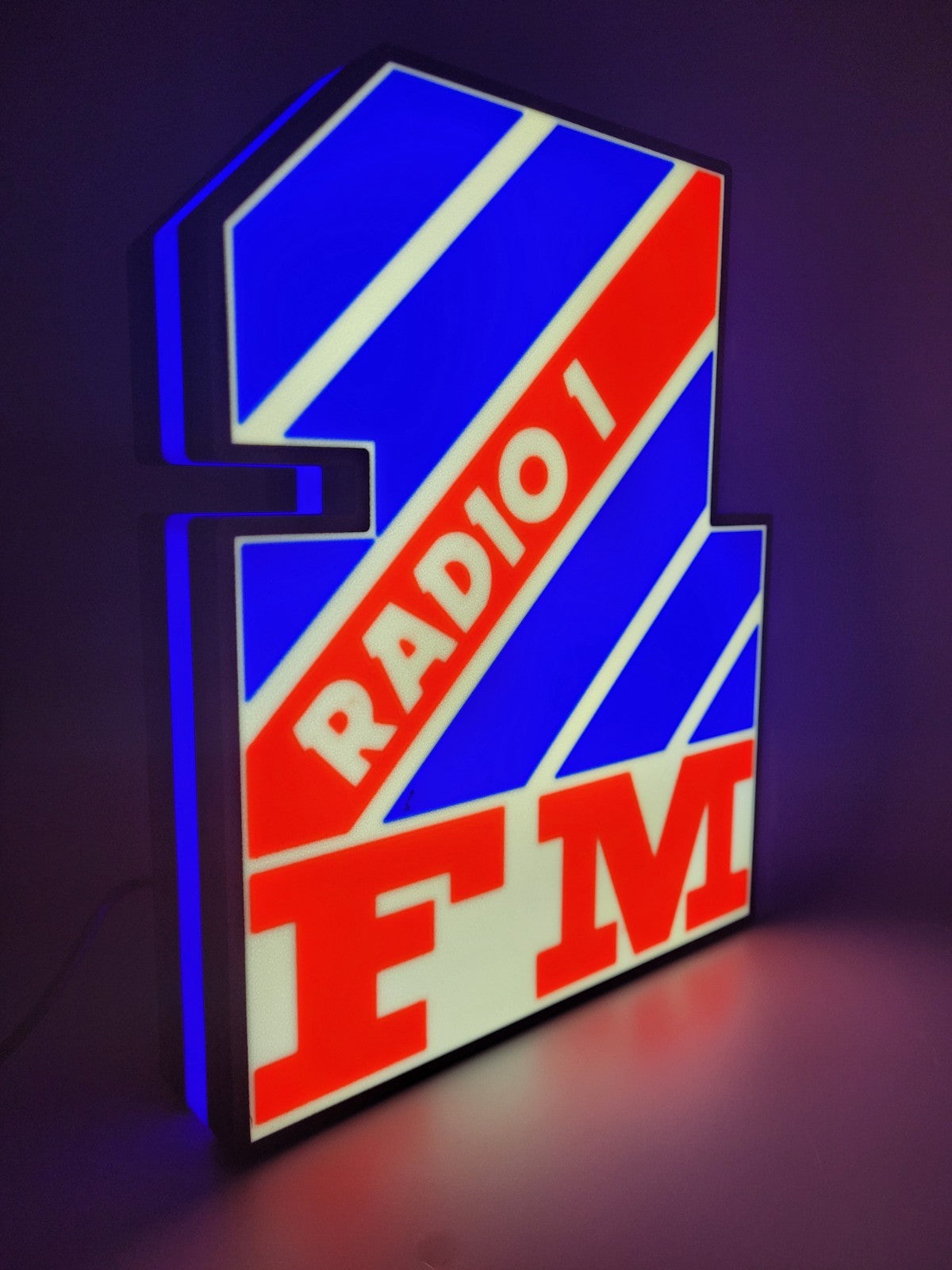 radio 1 led light sign with illuminated logo viewed from side view