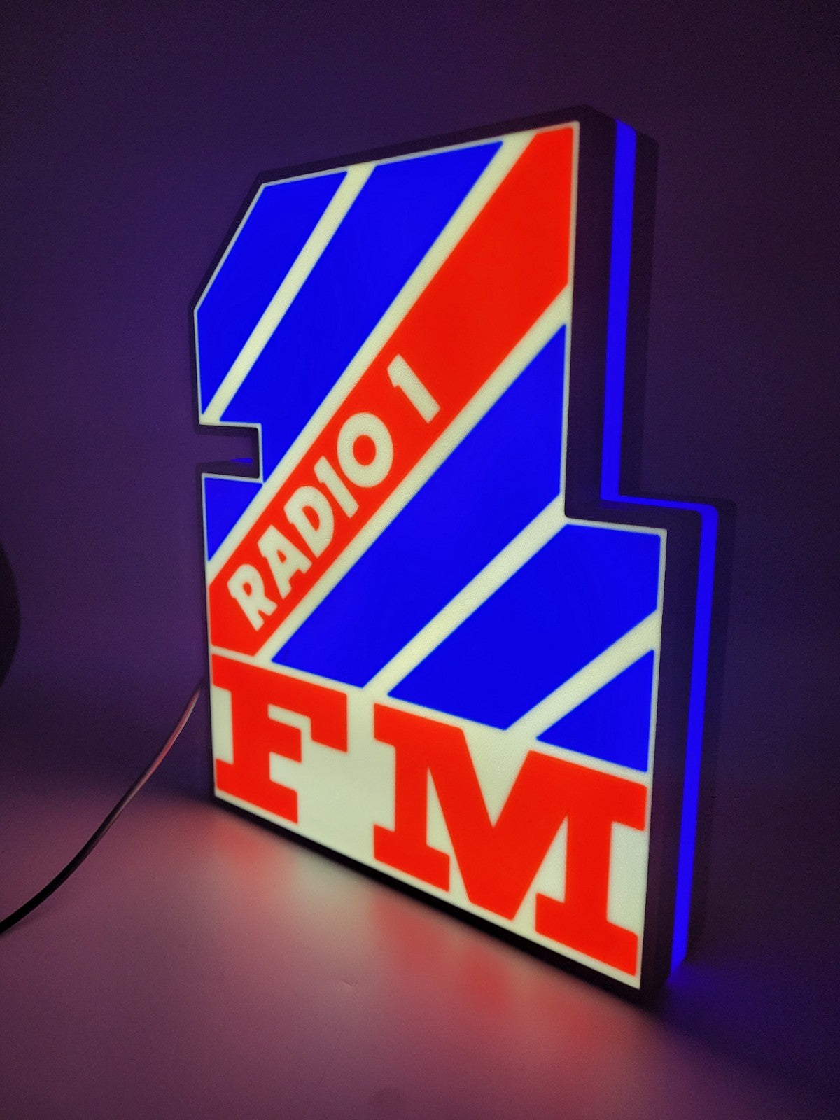 radio 1 led light sign with illuminated logo viewed from side view