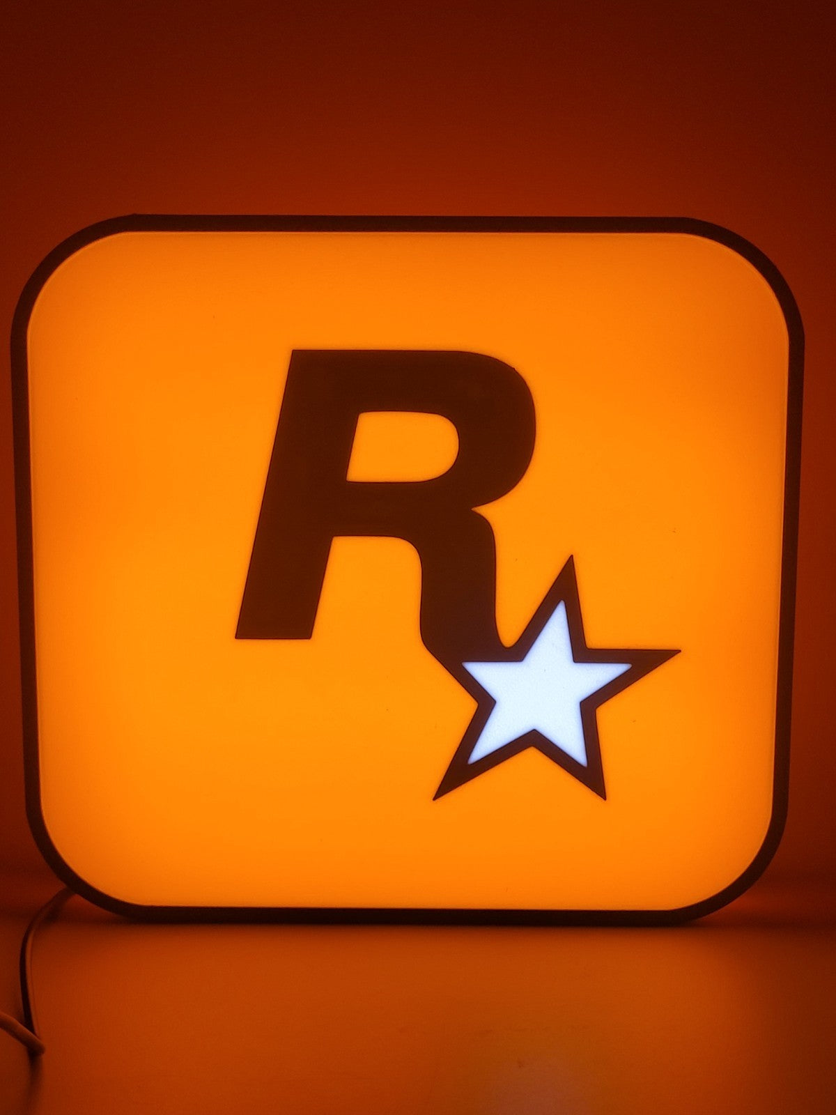 Rockstar LED light sign with illuminated logo viewed from straight on