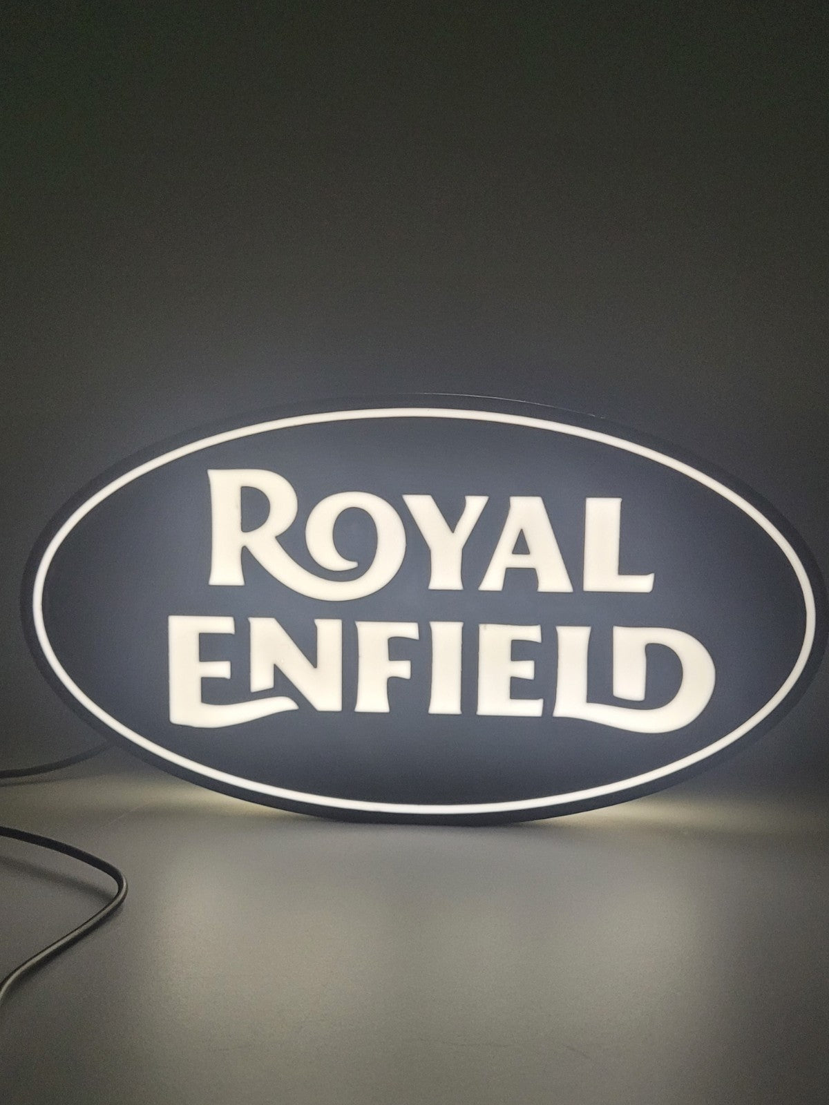 Royal Enfield LED light sign with illuminated logo viewed from straight on