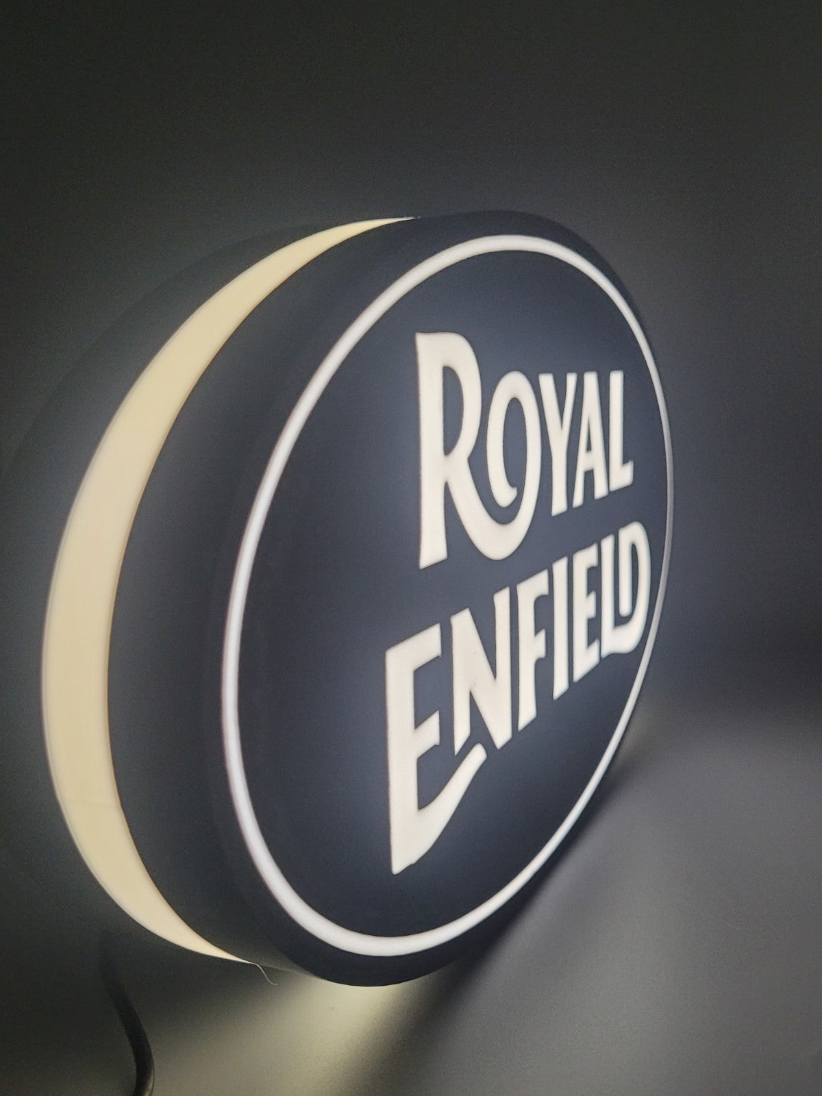 royal enfield led light sign with illuminated logo viewed from side view