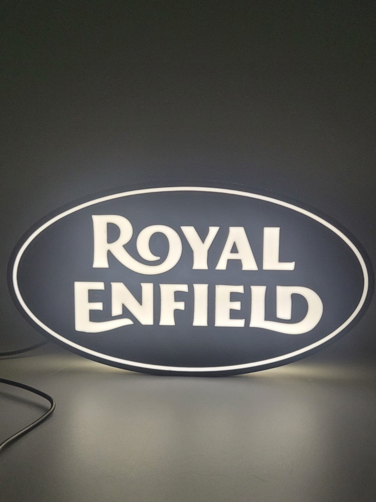 Royal Enfield LED light sign with illuminated logo viewed from straight on