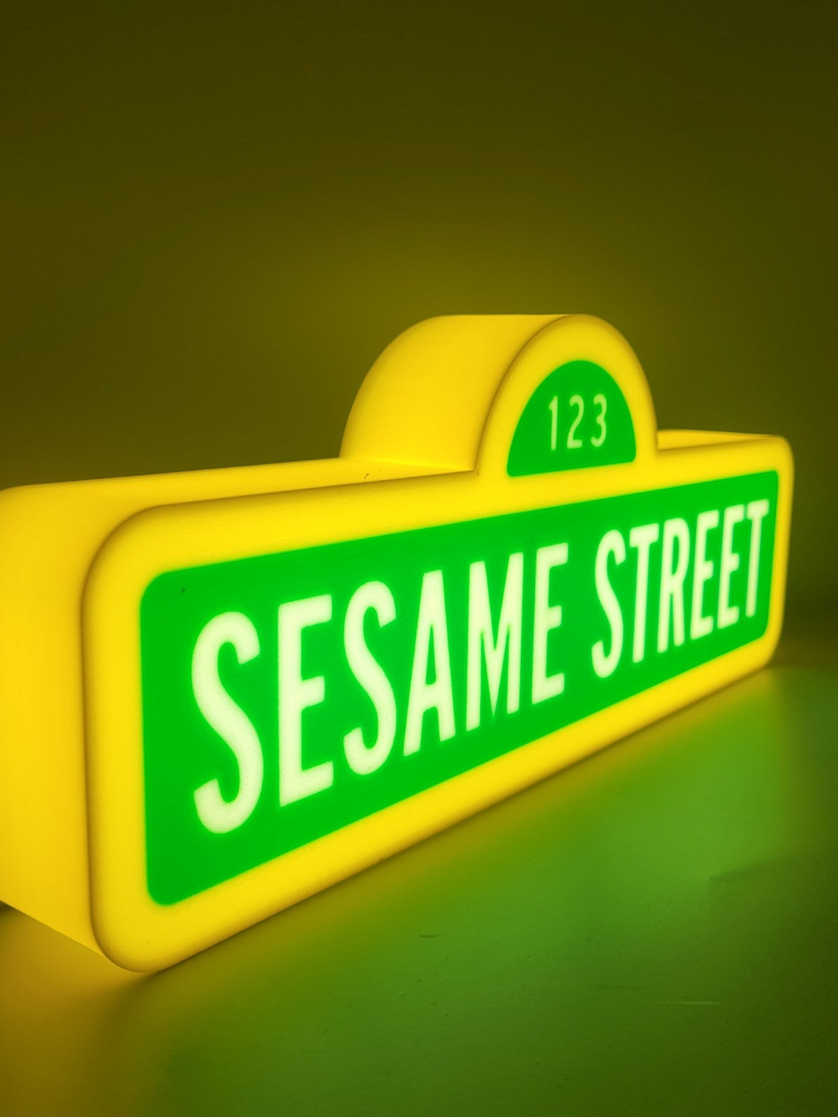 sesame street led light sign with illuminated logo viewed from side view