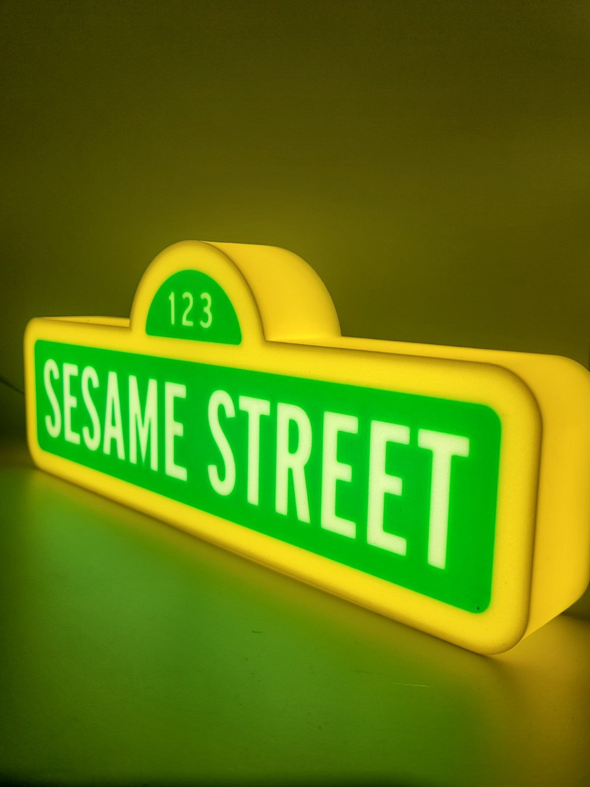 sesame street led light sign with illuminated logo viewed from side view