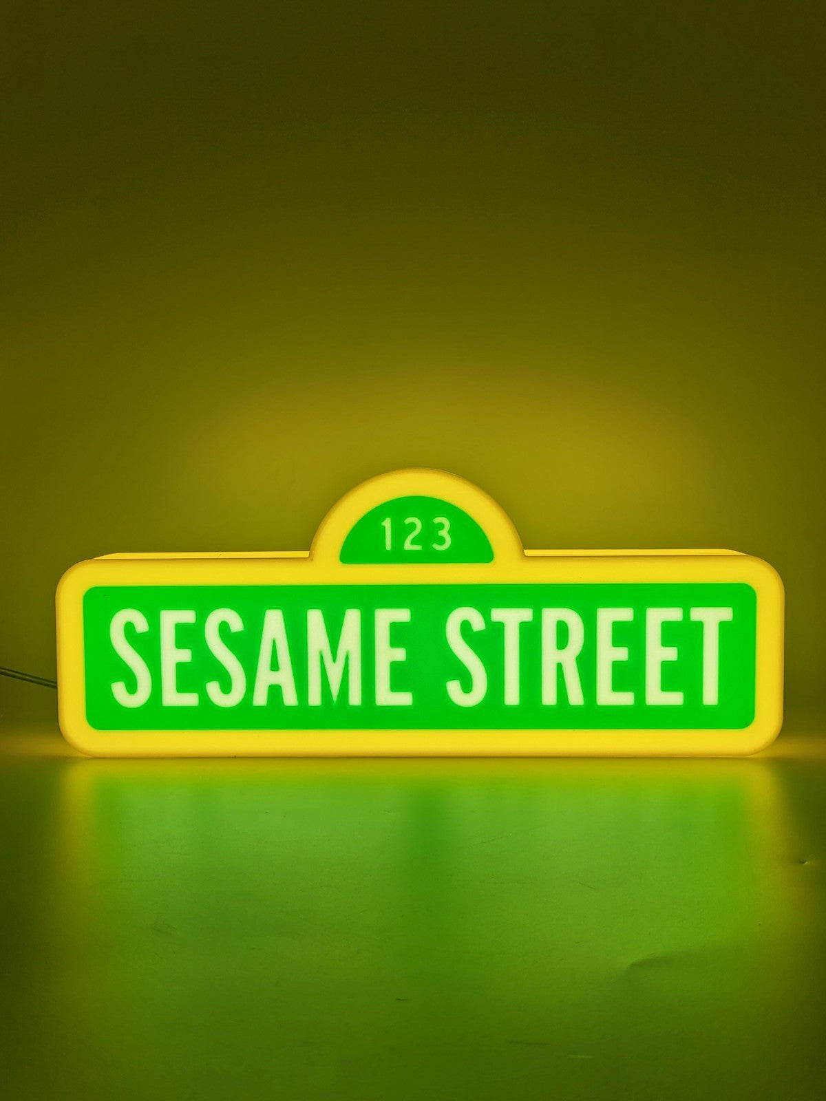 sesame street led light sign with illuminated logo viewed from straight on