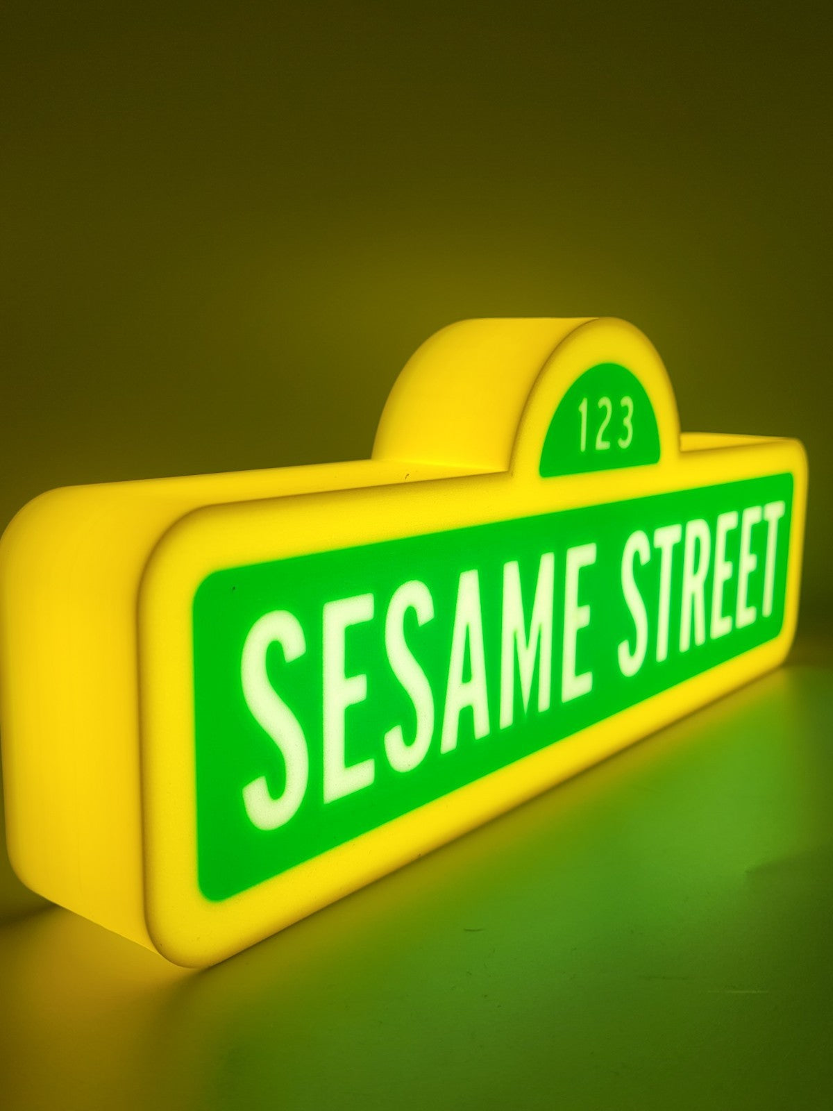 sesame street led light sign with illuminated logo viewed from side view