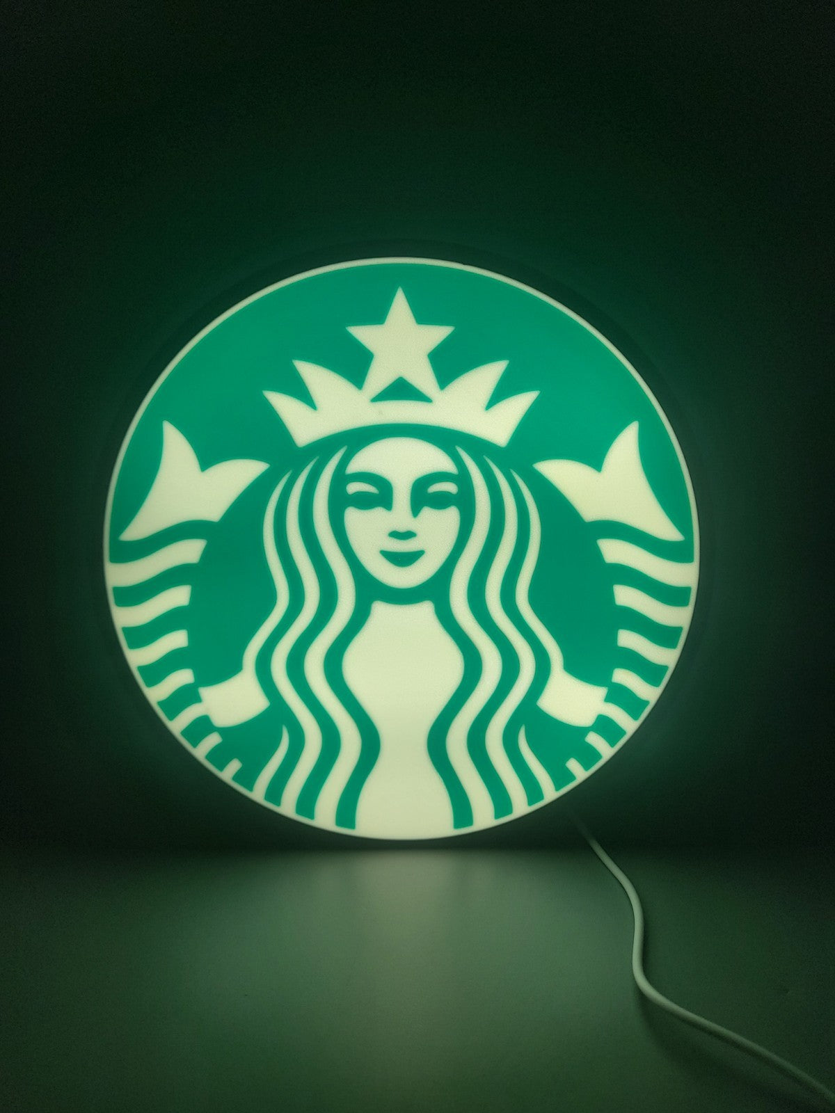 Starbucks LED light sign with illuminated logo viewed from straight on