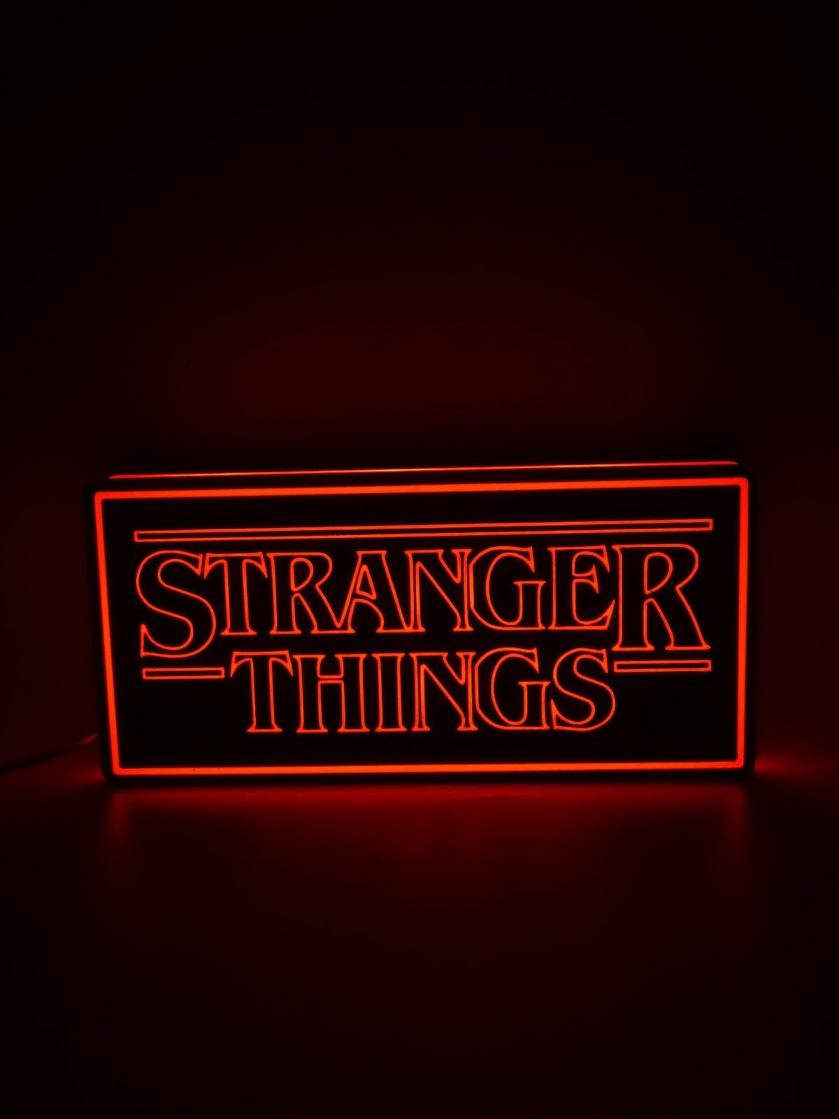 stranger things led light sign with illuminated logo viewed from straight on