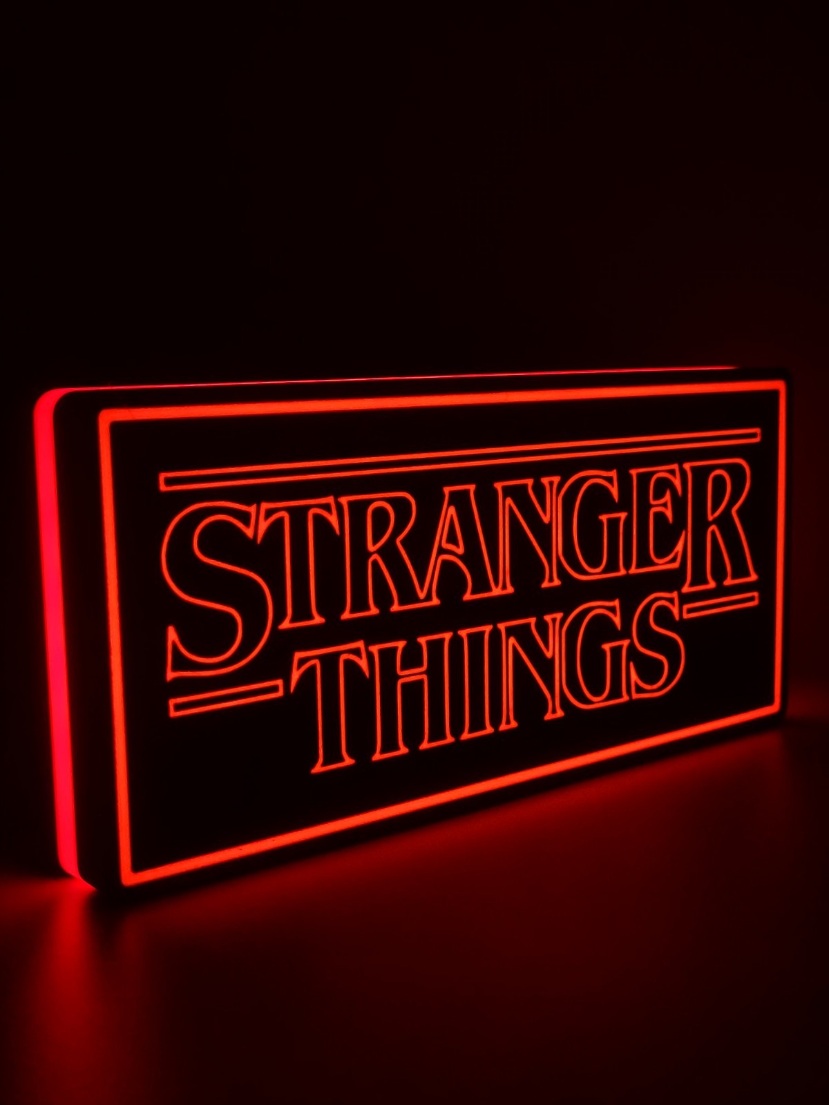 Stranger Things led light sign with illuminated logo viewed from side view