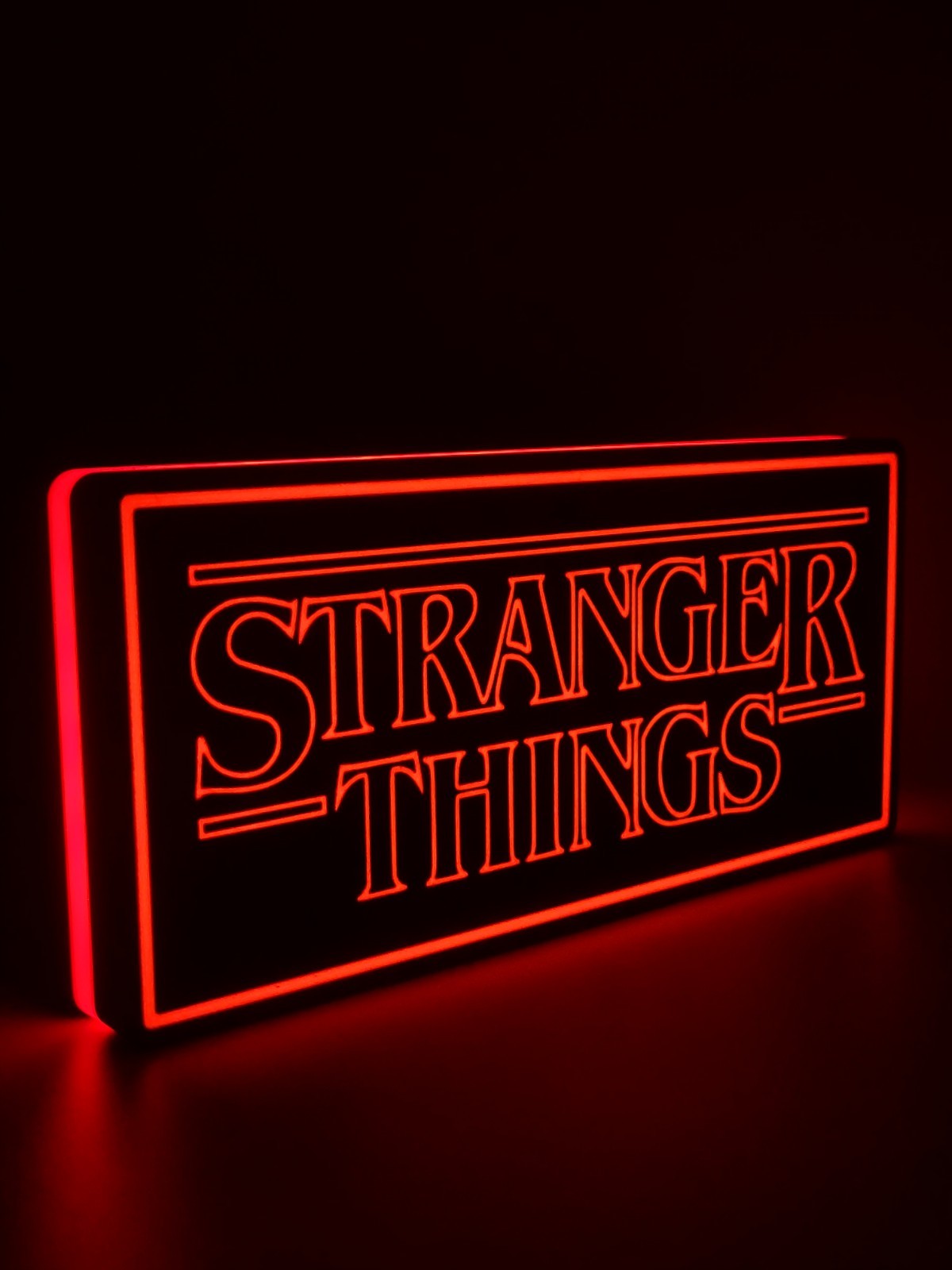 Stranger Things led light sign with illuminated logo viewed from side view