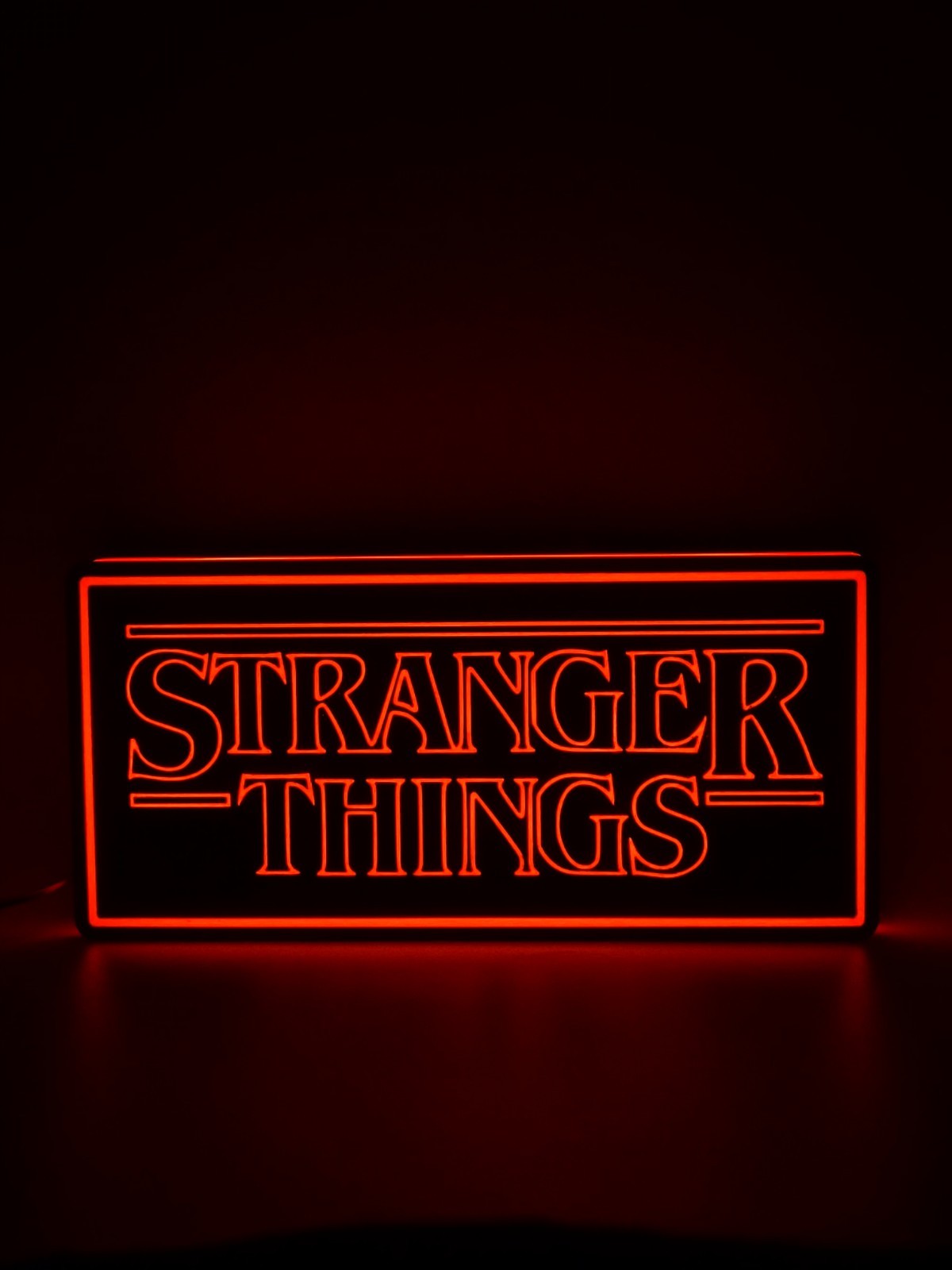 stranger things led light sign with illuminated logo viewed from straight on