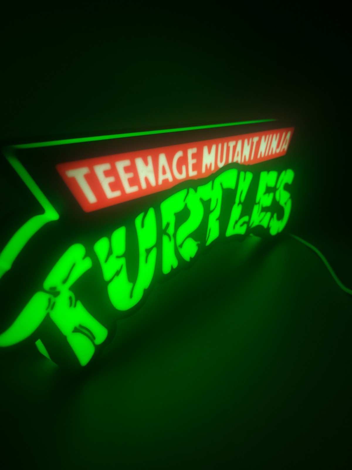 tenage mutant ninja turtles  LED light sign with illuminated logo viewed from side view