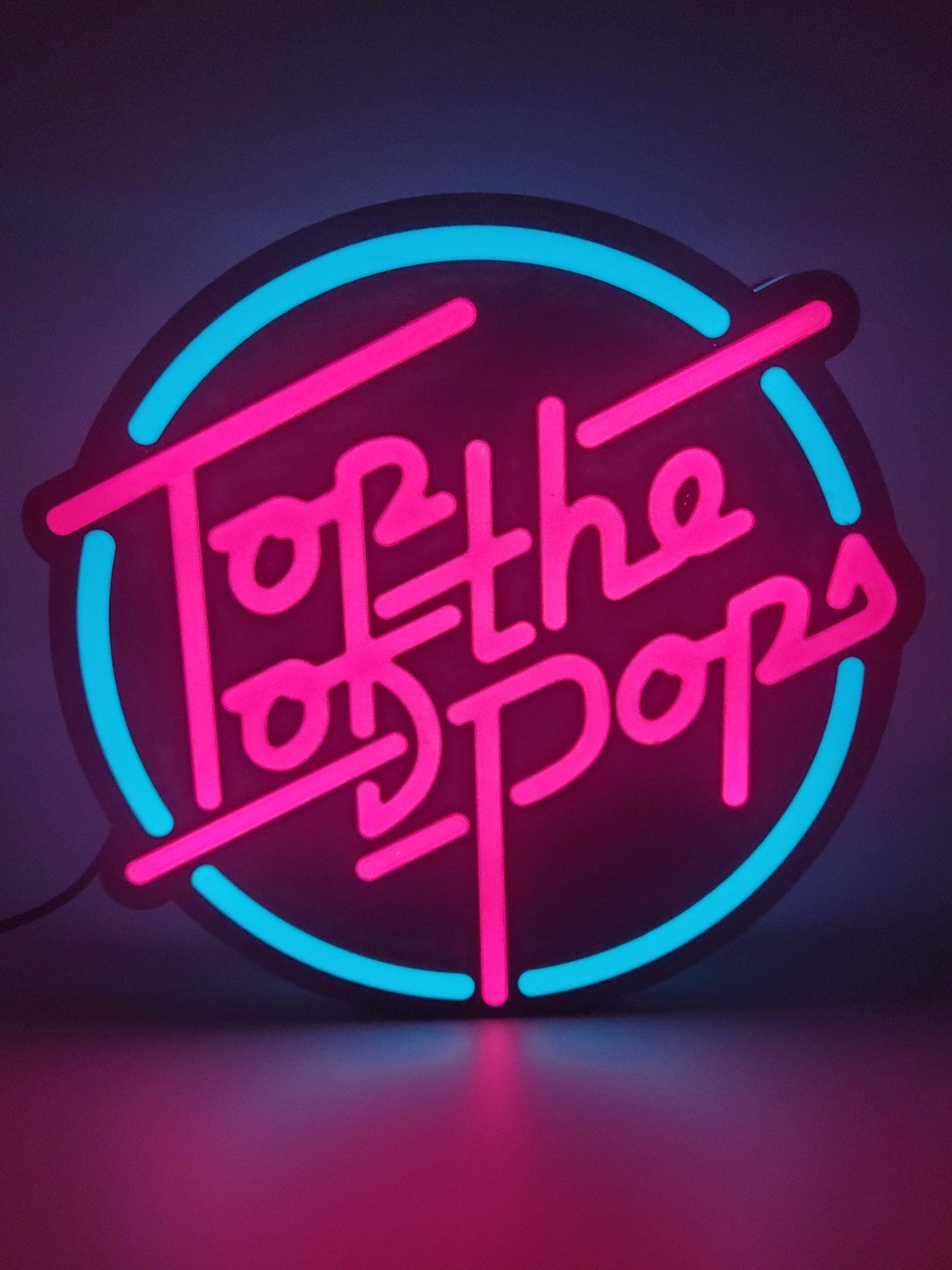 Top Of The Pop's LED light sign with illuminated logo viewed from straight on