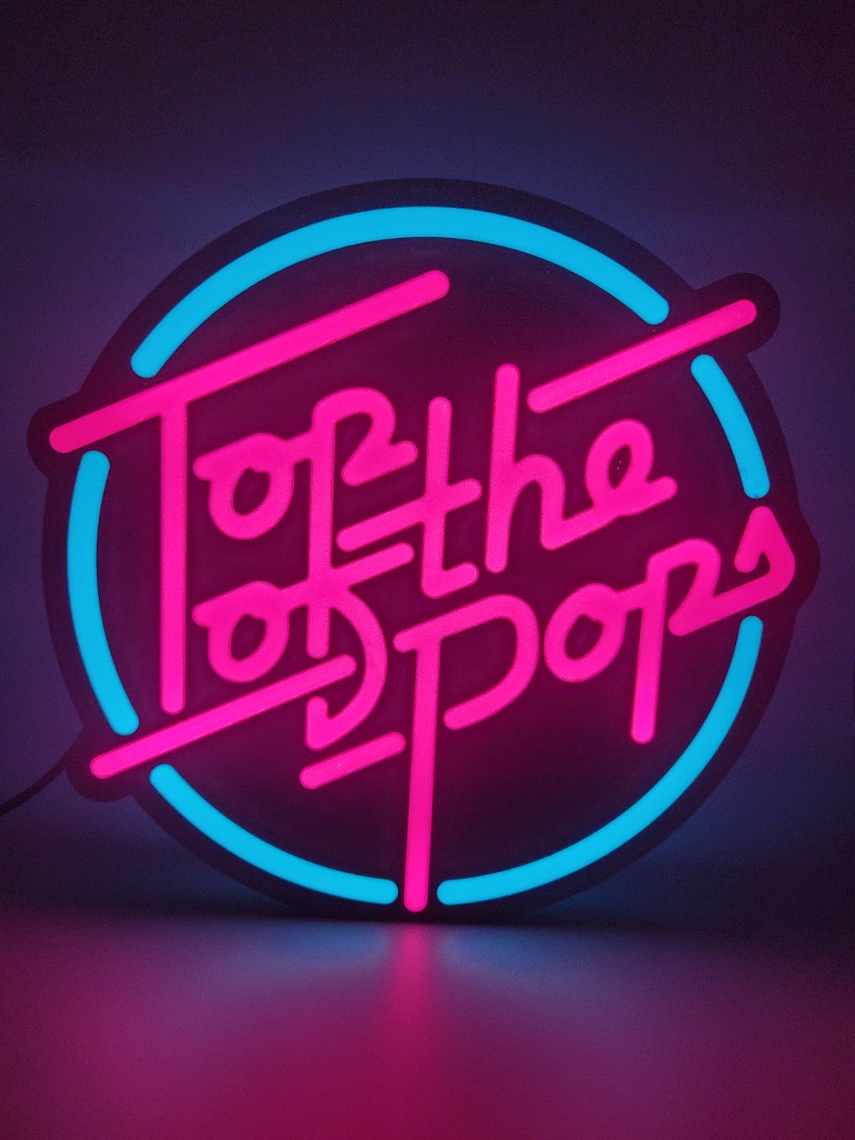 Top Of The Pop's LED light sign with illuminated logo viewed from straight on