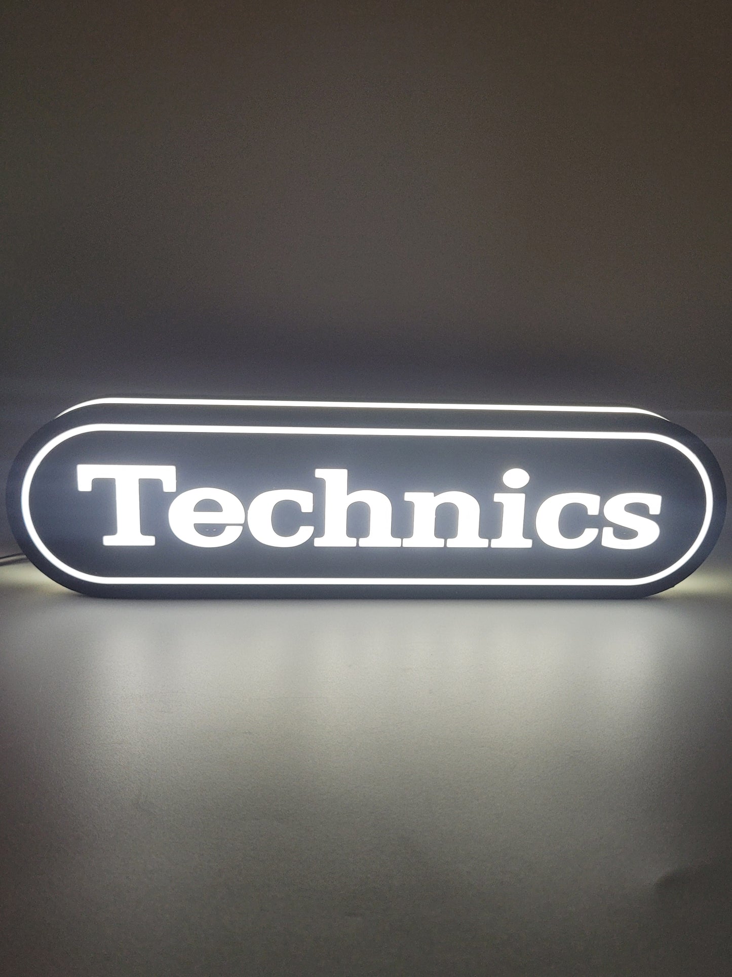 Technics LED light sign with illuminated logo viewed from straight on