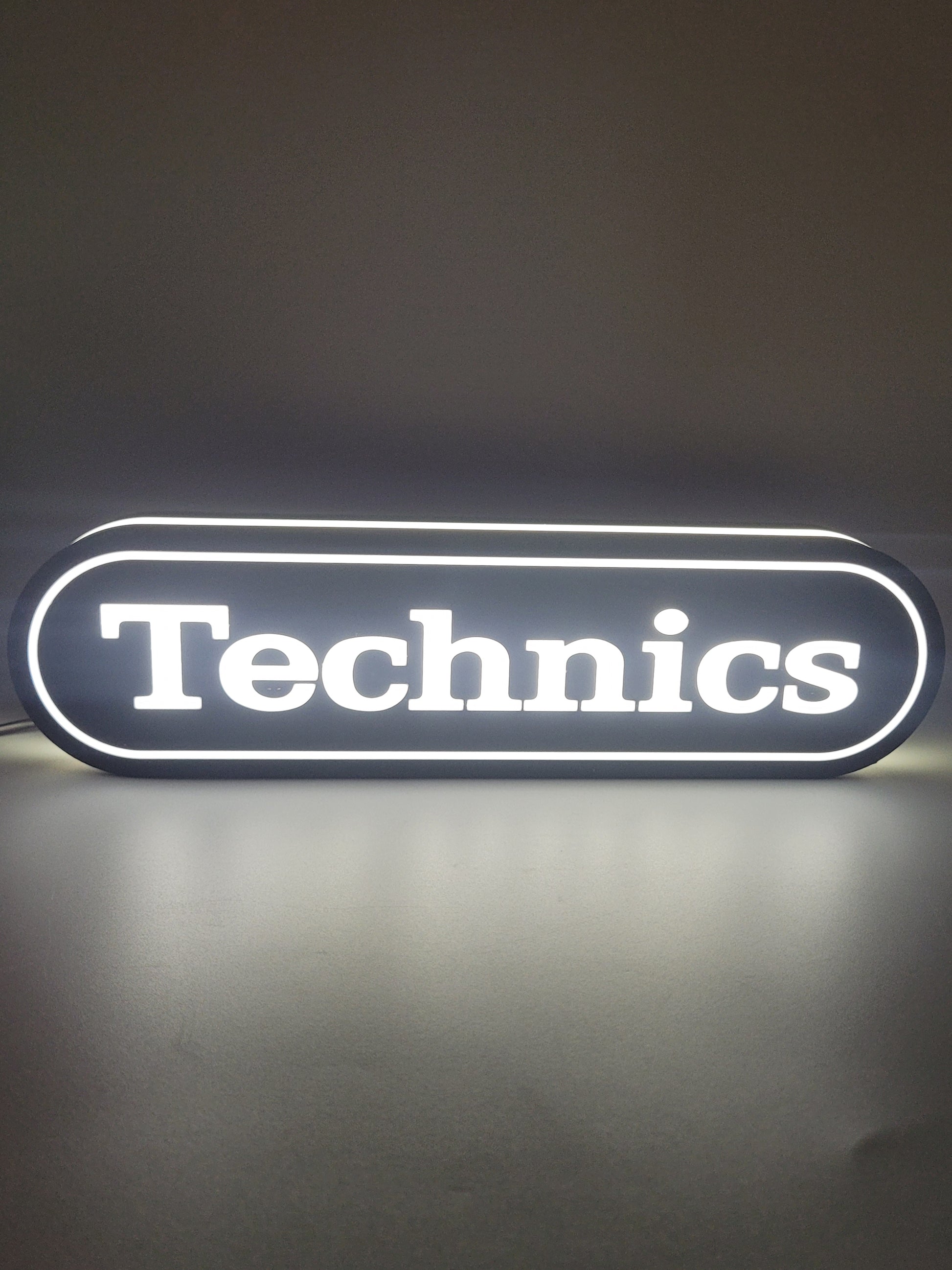Technics LED light sign with illuminated logo viewed from straight on