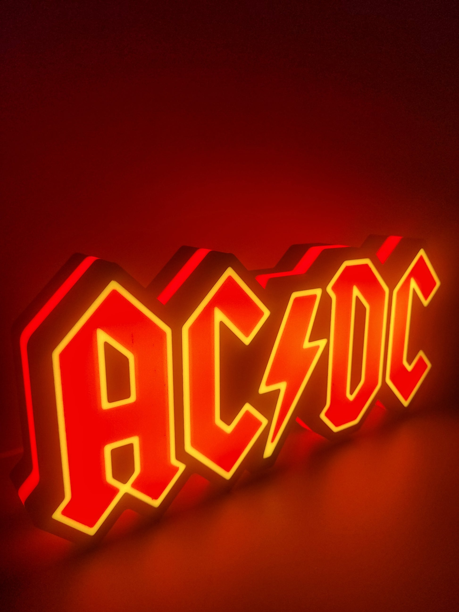 ac/dc led light sign with illuminated logo viewed from side view