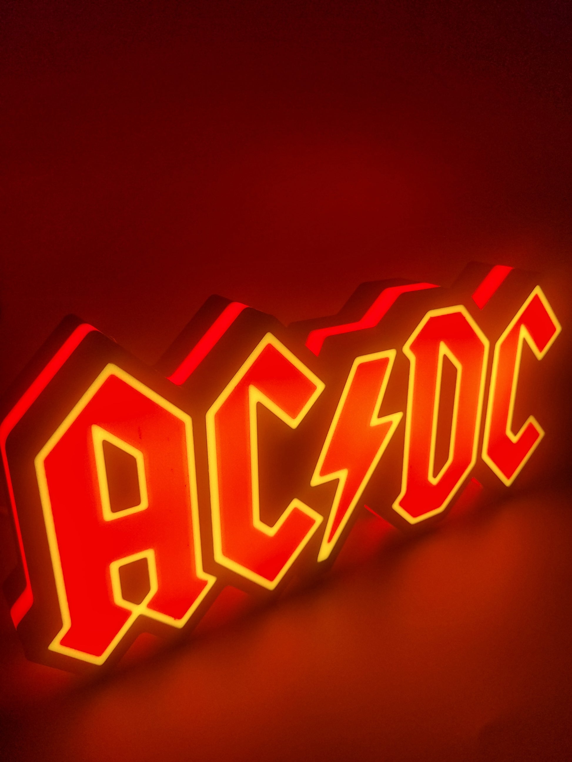 ac/dc led light sign with illuminated logo viewed from side view