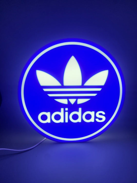 Adidas led light sign with illuminated logo viewed from straight on 