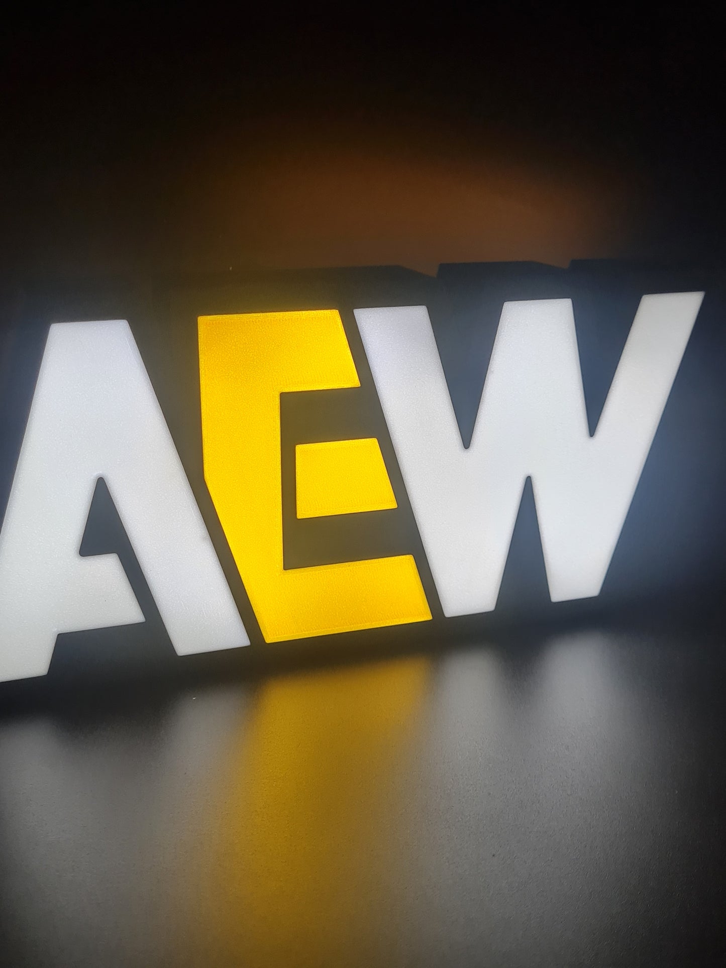 aew led light sign with illuminated logo viewed from side view