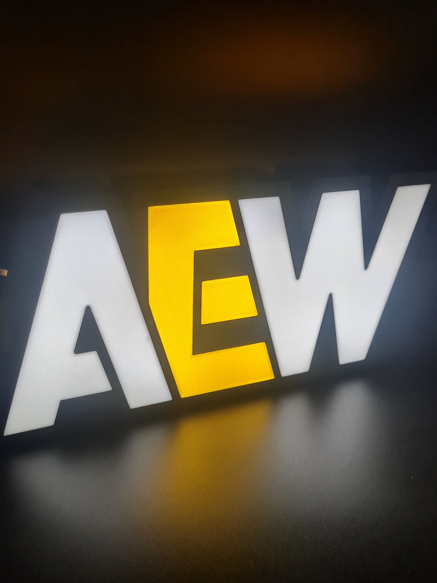 aew led light sign with illuminated logo viewed from side view