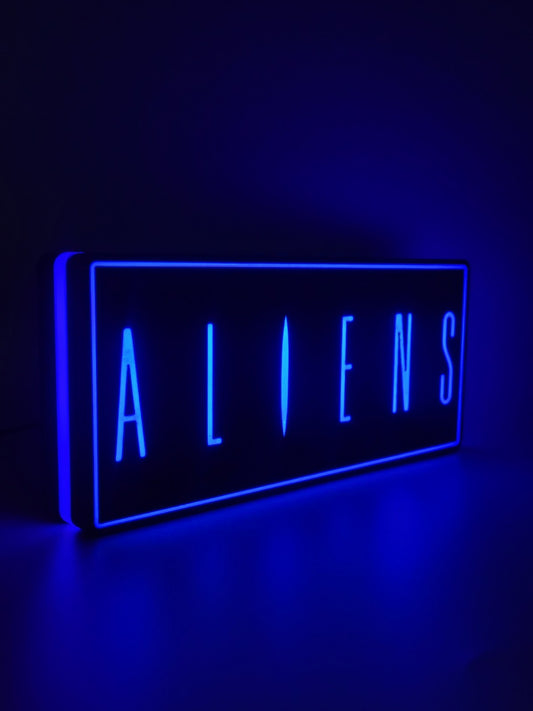 Aliens led light sign with illuminated logo viewed from side view