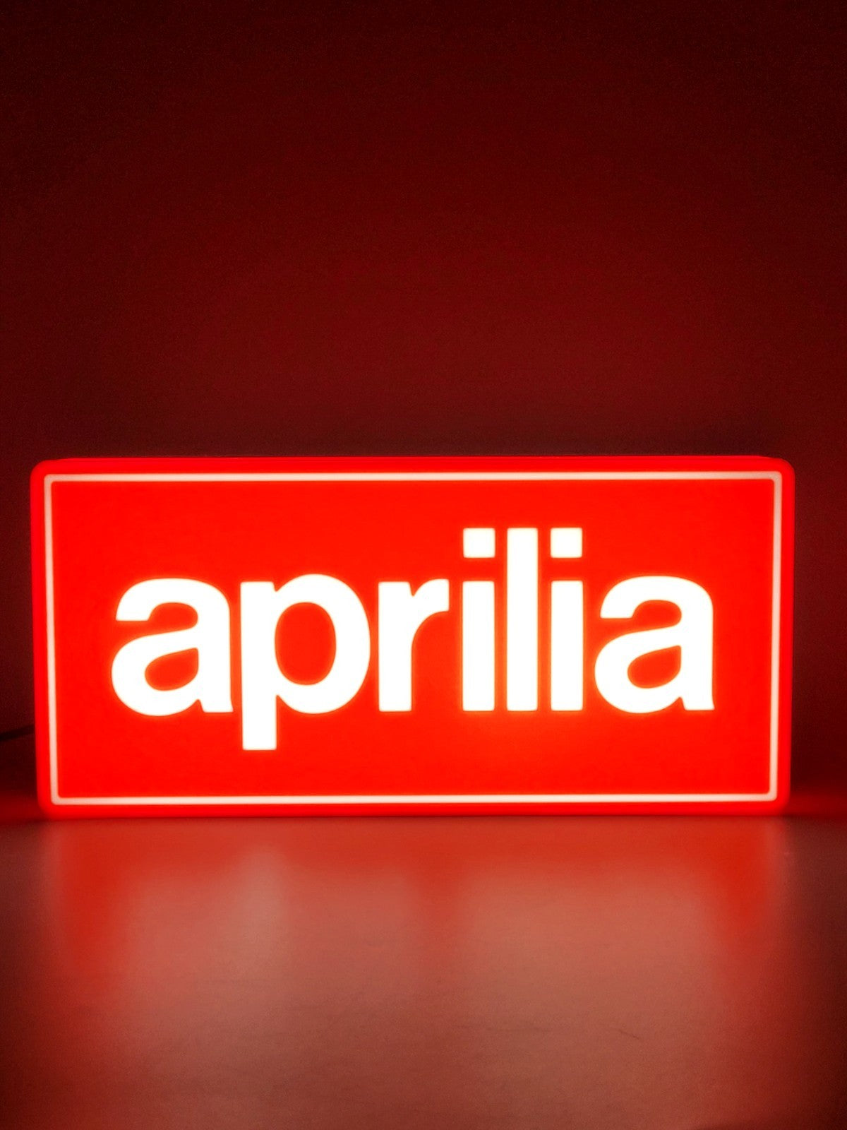 Aprilia led light sign with illuminated logo viewed from straight on