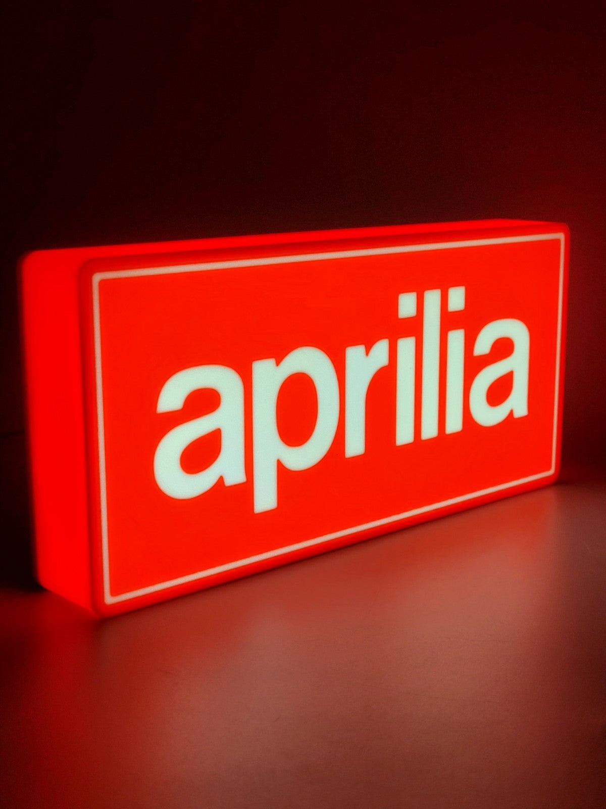 aprilia led light sign with illuminated logo viewed from side view