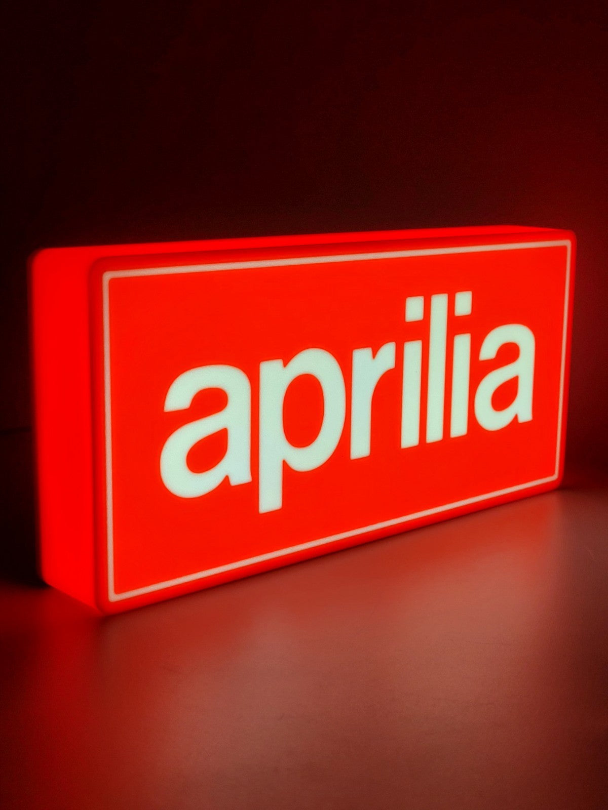 Aprilia led light sign with illuminated logo viewed from side view