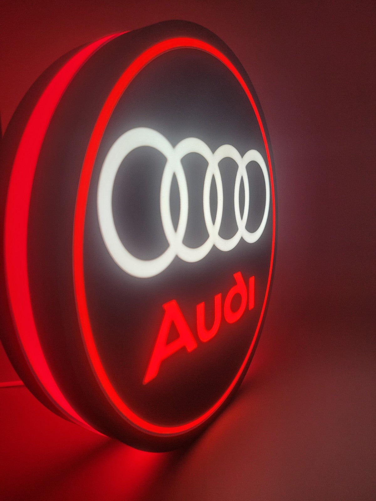 Audi led light sign with illuminated logo viewed from side view