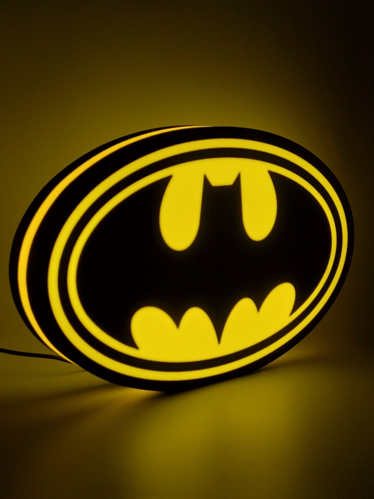Batman led light sign with illuminated logo viewed from side view