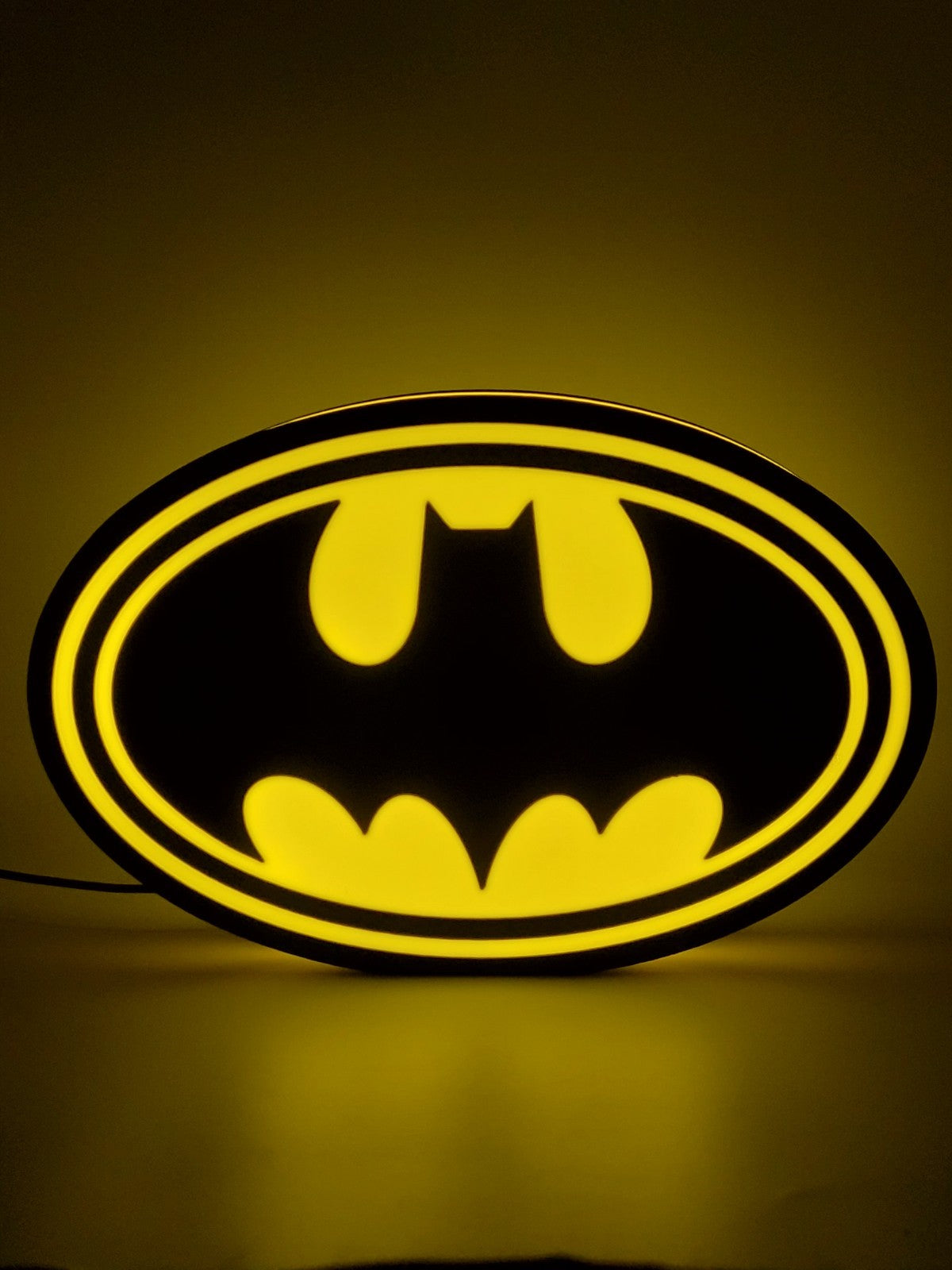 Batman led light sign with illuminated logo viewed from straight on