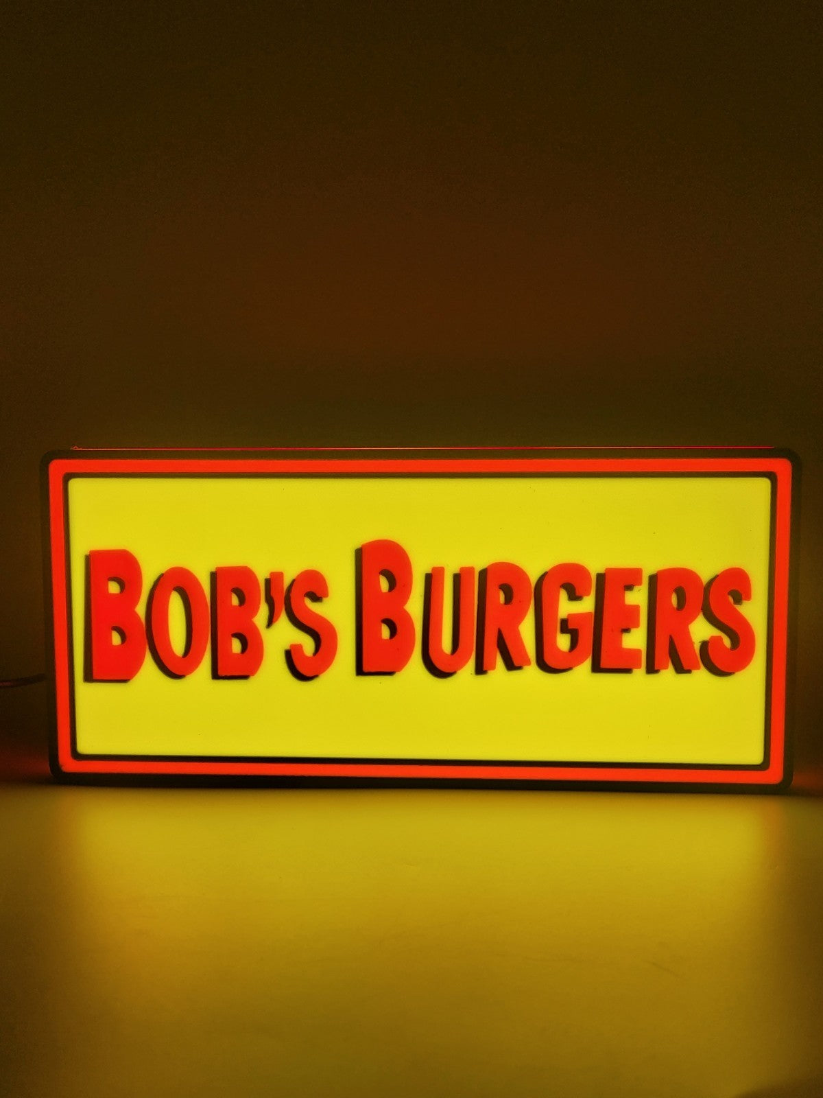 bobs burgers led light sign with illuminated logo viewed from straight on