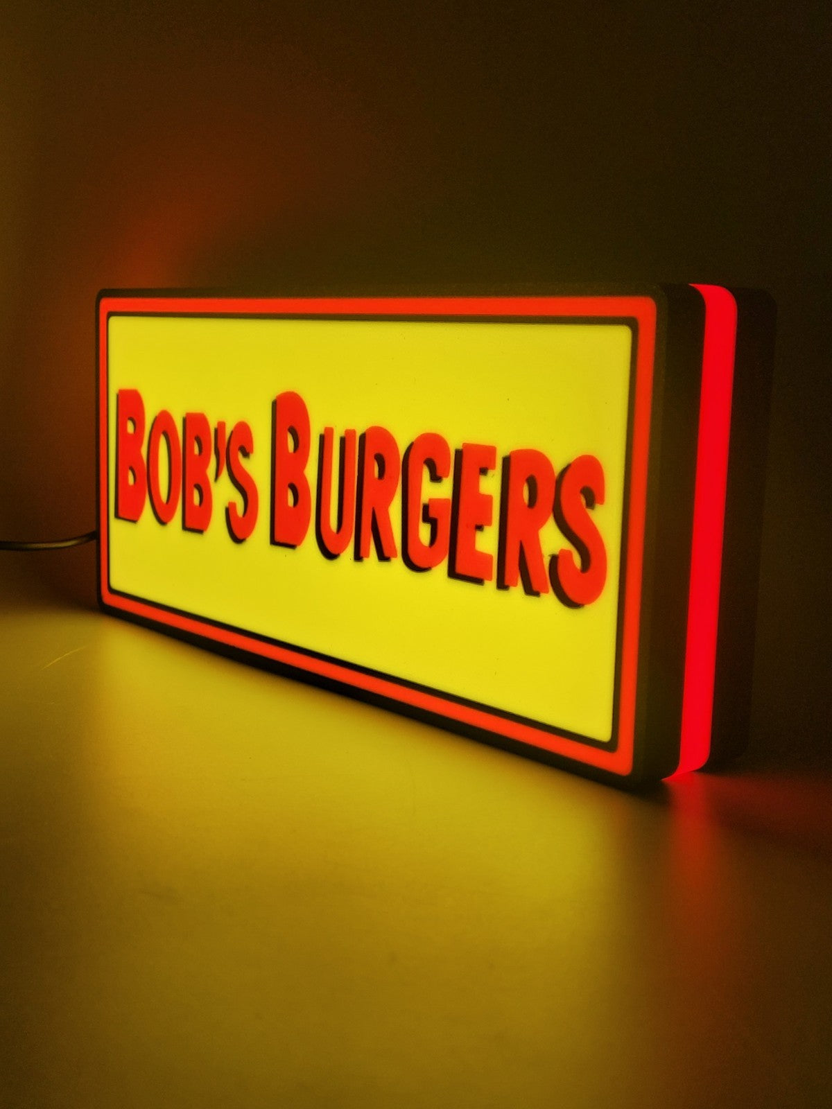 bob's burgers led light sign with illuminated logo viewed from side view