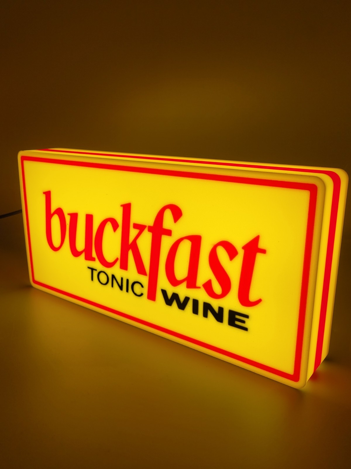 BUCKFAST led light sign with illuminated logo viewed from side view
