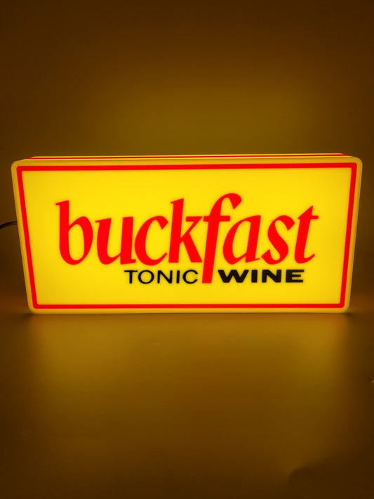 BUCKFAST led light sign with illuminated logo viewed from straight on
