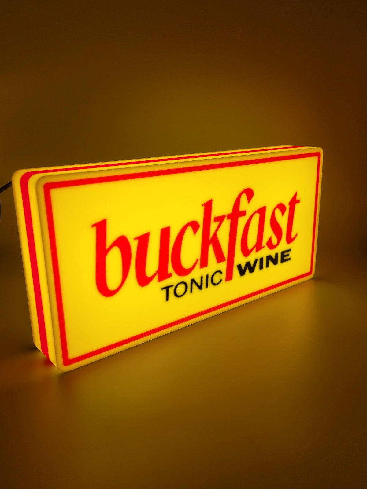 BUCKFAST led light sign with illuminated logo viewed from side view