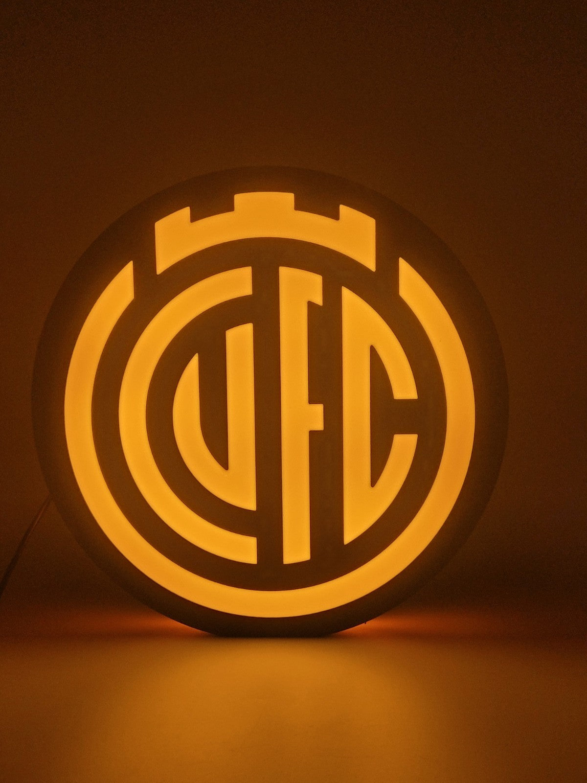 Cambridge FC led light sign with illuminated logo viewed from straight on