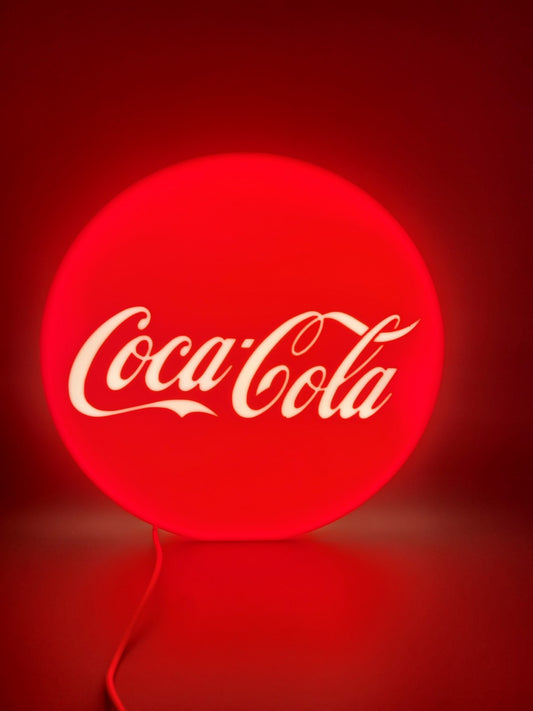 coca-cola round LED light sign with illuminated logo viewed from straight on