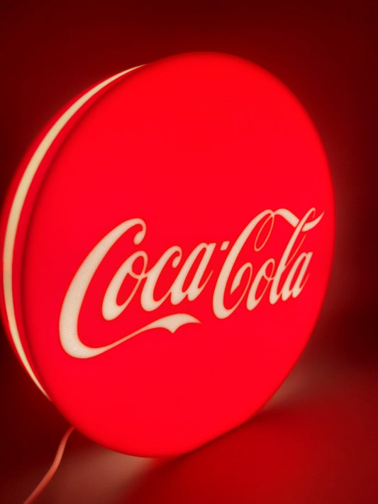 Coca-cola LED light sign with illuminated logo viewed from side view