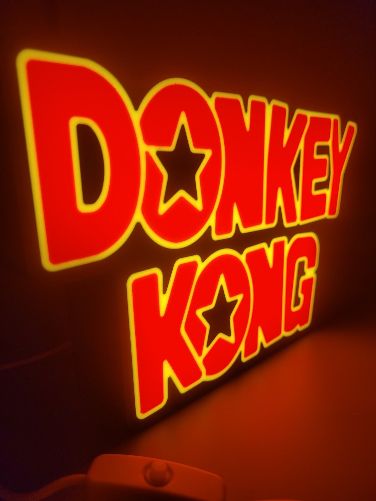 Donkey Kong led light sign with illuminated logo viewed from side view