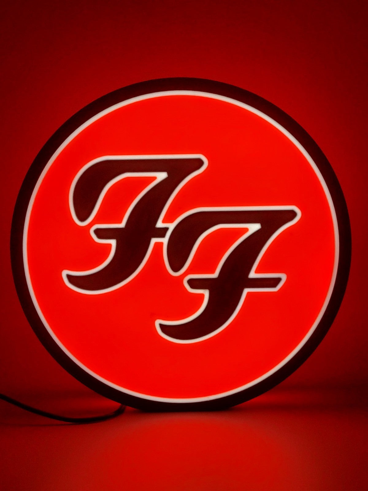 foo fighters led light sign with illuminated logo viewed from straight on