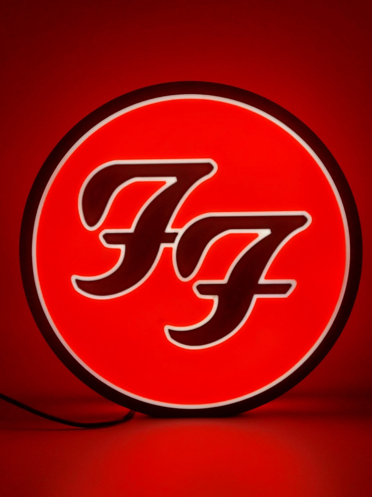foo fighters led light sign with illuminated logo viewed from straight on