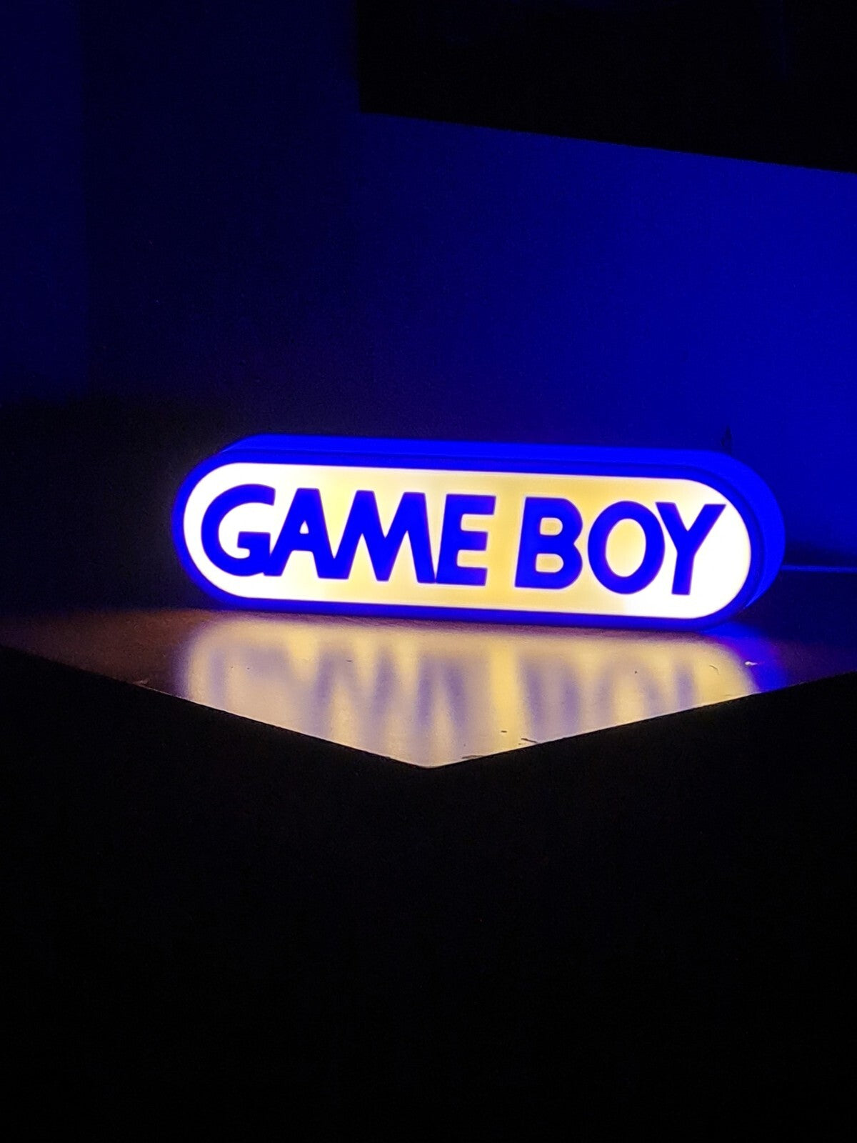 Game boy LED light sign with illuminated logo viewed from straight on