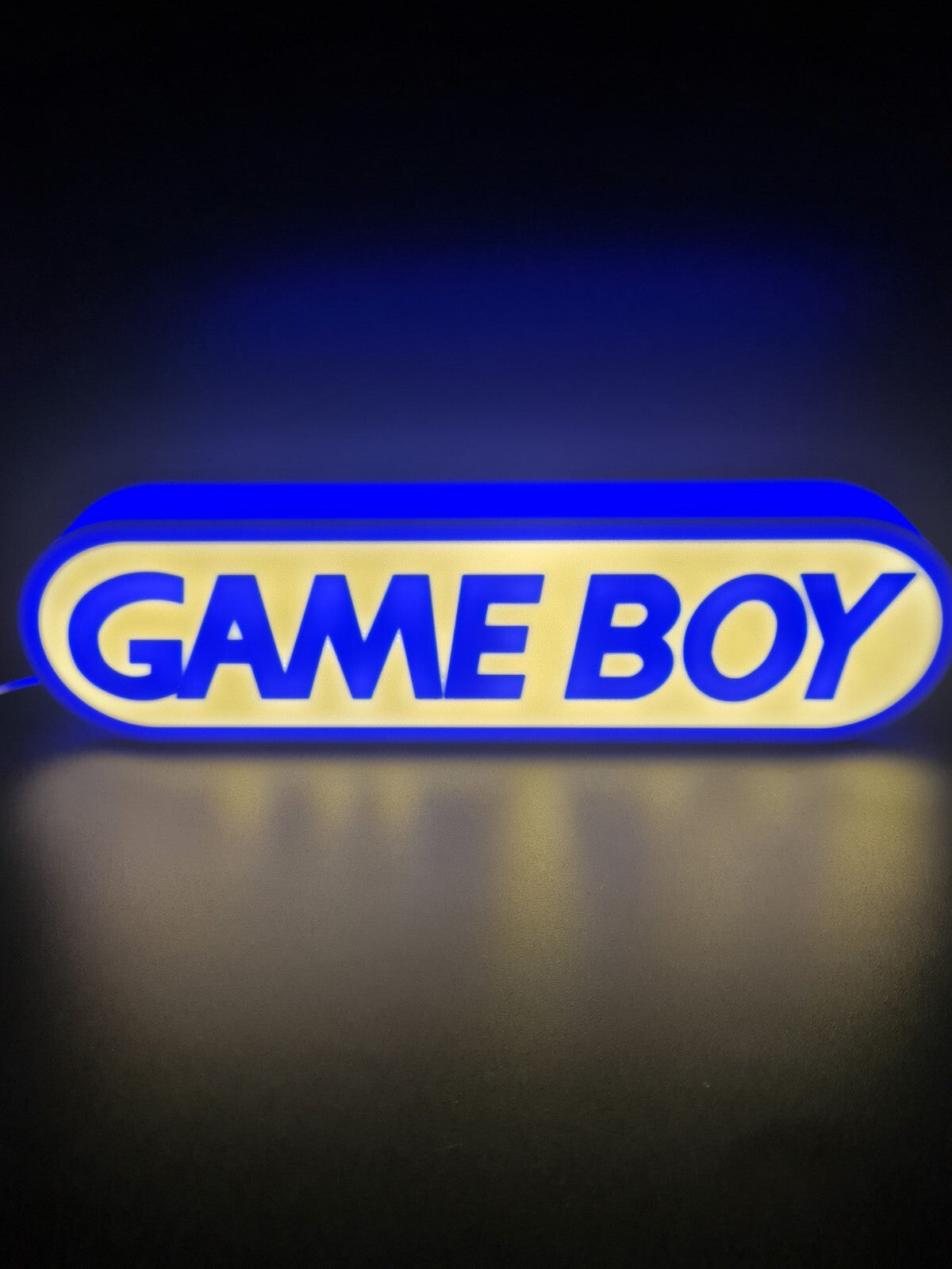 Game boy LED light sign with illuminated logo viewed from straight on