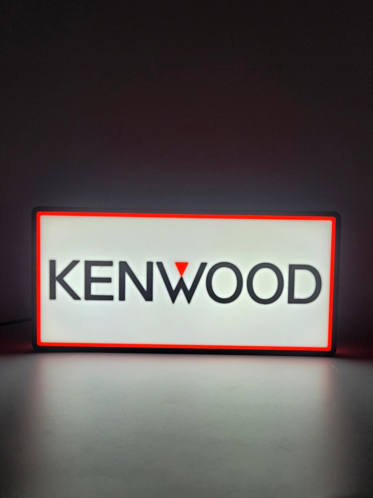 KENWOOD led light sign with illuminated logo viewed from straight on